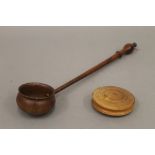 A treen box and ladle. The latter 33.5 cm long.