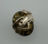 A silver dress ring set with a frog. Ring Size N.