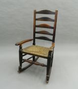A 19th century elm and ash ladder back rocking chair. 101 cm high.