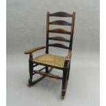 A 19th century elm and ash ladder back rocking chair. 101 cm high.