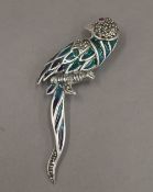 A silver plique-a-jour brooch formed as a parrot. 7 cm wide.