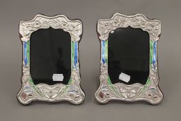 A pair of silver Art Nouveau style photograph frames. 21 cm high.