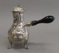 A silver embossed chocolate pot. 21 cm high. 19.6 troy ounces total weight.