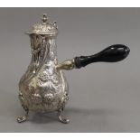 A silver embossed chocolate pot. 21 cm high. 19.6 troy ounces total weight.