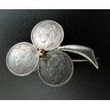 Three Dutch silver coins formed into a brooch. 3.5 cm wide.