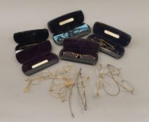 A collection of vintage spectacles, some cased.