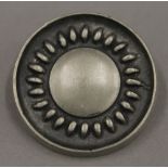 A Swedish pewter brooch by Tenn. 3.5 cm diameter.