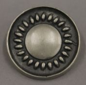 A Swedish pewter brooch by Tenn. 3.5 cm diameter.