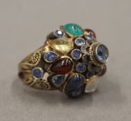 An unmarked gold multi-gem set ring. Ring Size G.