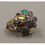 An unmarked gold multi-gem set ring. Ring Size G.