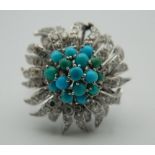 A 9 ct white gold diamond and turquoise floral target ring. Ring Size N/O.