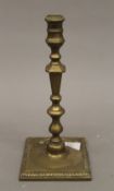 An 18th century brass candlestick. 26 cm high.