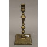 An 18th century brass candlestick. 26 cm high.