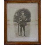 A maple framed photograph of a soldier and a 19th century satirical print. The latter 24 x 35.5 cm.