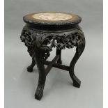 A Chinese marble topped stand. 49 cm high.