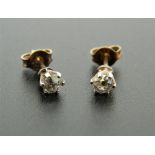 A pair of 9 ct gold diamond ear studs. Each 4 mm diameter.