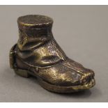 A brass vesta formed as a boot. 5 cm long.