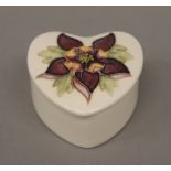 A Moorcroft heart shaped trinket pot and a boxed Wedgwood trinket pot. The former 3.5 cm high.