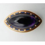 An unmarked gold amethyst and blue enamelled brooch/pendant. 3.5 cm wide. 7 grammes total weight.