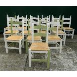 A set of fourteen modern painted rush seated dining chairs. Each 47 cm wide.