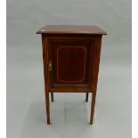 An Edwardian inlaid mahogany pot cupboard. 75 cm high.