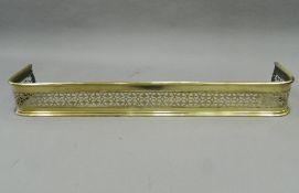 A Victorian pierced brass fender. 133 cm wide.