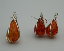 A pair of dress earrings, together with matching pendant. The latter 4 cm high.