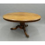 A Victorian rosewood loo table. 150 cm long.