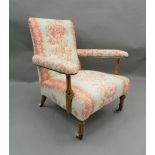 A Victorian upholstered open armchair. 66 cm wide.