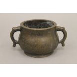 A small Chinese bronze twin handled censer. 16 cm wide.