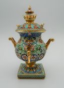 A miniature enamel and silver gilt samovar, bearing Russian marks. 10 cm high.