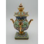 A miniature enamel and silver gilt samovar, bearing Russian marks. 10 cm high.