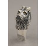 A silver whistle formed as a dog's head. 3.5 cm high.