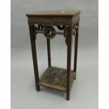 A Chinese hardwood urn stand. 75 cm high.