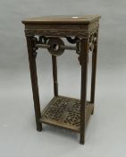 A Chinese hardwood urn stand. 75 cm high.