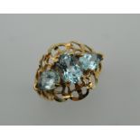 A 10 K gold three stone aquamarine ring. Ring Size P.