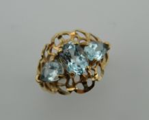 A 10 K gold three stone aquamarine ring. Ring Size P.