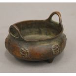 A small Chinese bronze censer decorated with calligraphy. 8.5 cm wide.