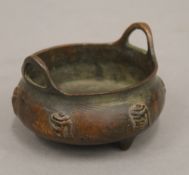 A small Chinese bronze censer decorated with calligraphy. 8.5 cm wide.