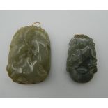 Two gold mounted jade pendants. The largest 4 cm high.
