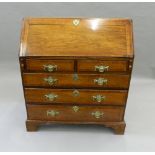 A George III oak crossbanded bureau. 94.5 cm wide.