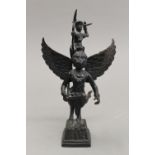 A bronze model of a winged god figure. 19 cm high.