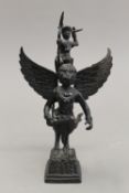 A bronze model of a winged god figure. 19 cm high.