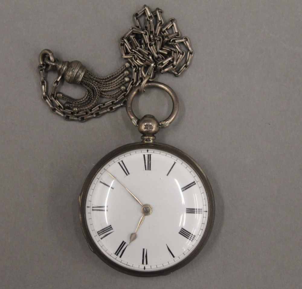 Two 19th century silver pocket watches on chains and a brass pocket watch case. - Image 5 of 12