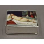 A silver pill box depicting a nude. 3 cm wide.