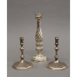 A pair of silver taper sticks and an unmarked Eastern candlestick. The former each 10 cm high. 8.