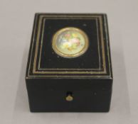 A 19th century French pocket watch holder, the lid set with a miniature. 8.5 cm long.