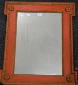 A red and gilt painted wall glass. 65.5 x 76 cm.