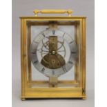 A brass cased skeleton clock. 25 cm high.