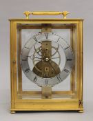 A brass cased skeleton clock. 25 cm high.